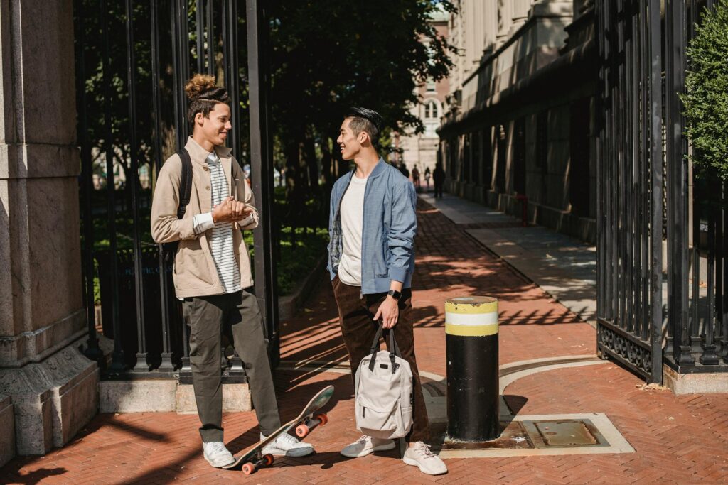 Photo by Armin Rimoldi: https://www.pexels.com/photo/content-diverse-male-friends-chatting-on-street-5553063/
